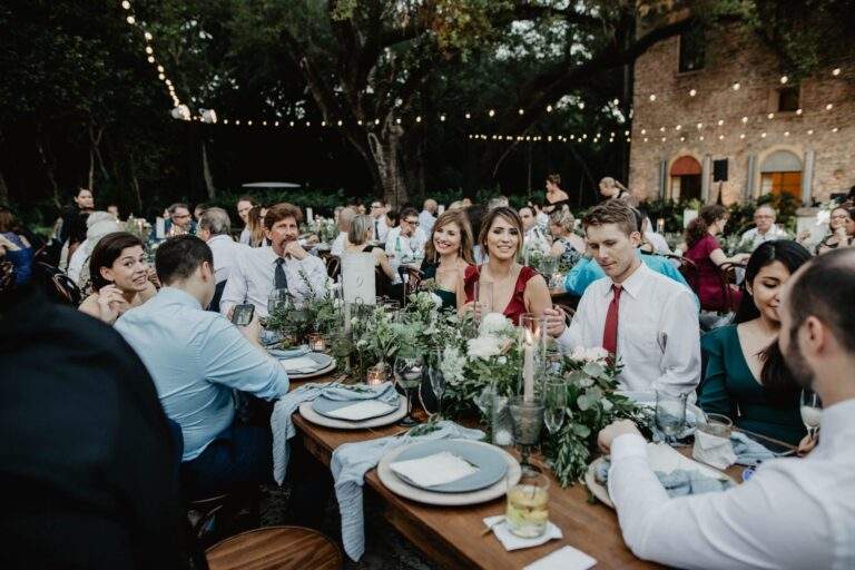 Decorated table settings filled with loved ones at a wedding reception.
